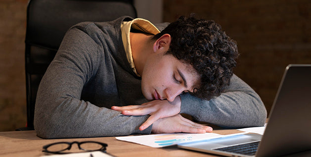 student sleeping on desk
