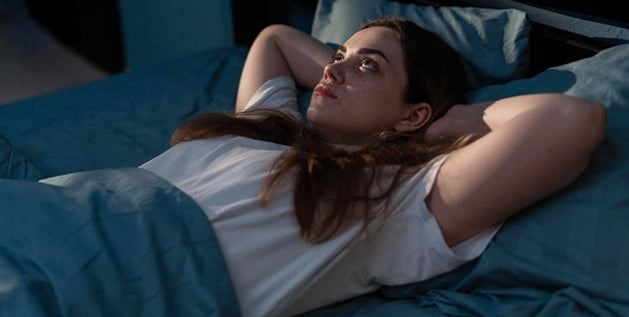 Insomnia - A person lying awake in bed at night 