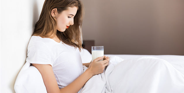 drinks that help you sleep at night - a women drinking warm milk for quality sleep